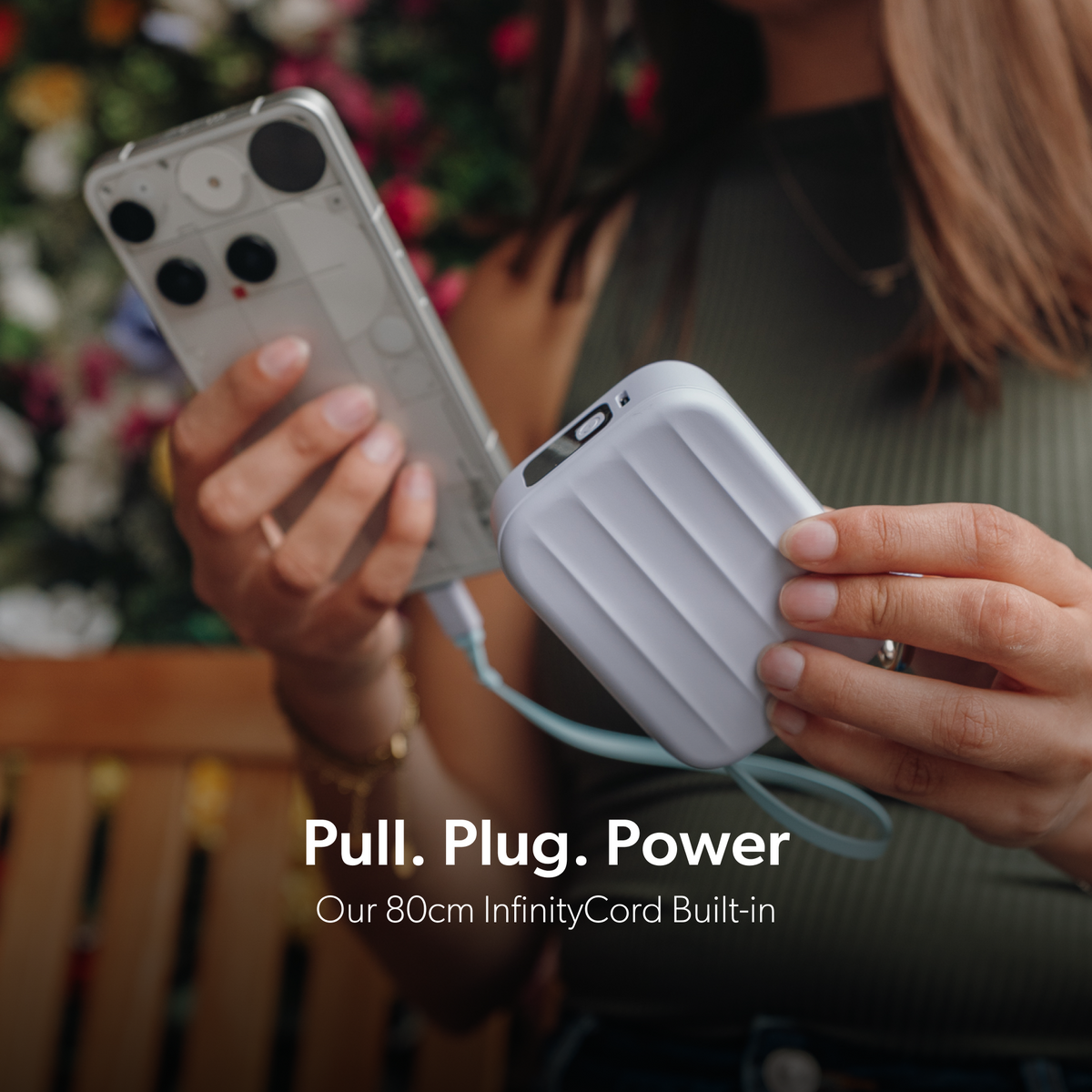 PowerPack Mini 2 charging a phone with its built-in 80cm retractable InfinityCord.