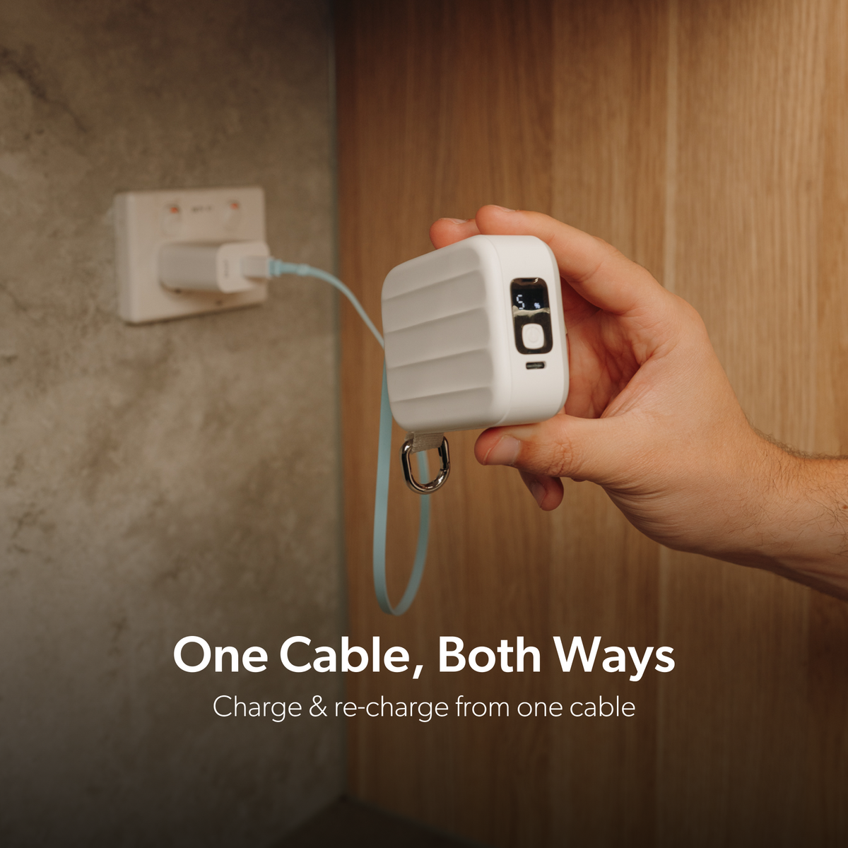 White PowerPack Mini 2 recharging at a wall charger through its built-in USB-C cable.