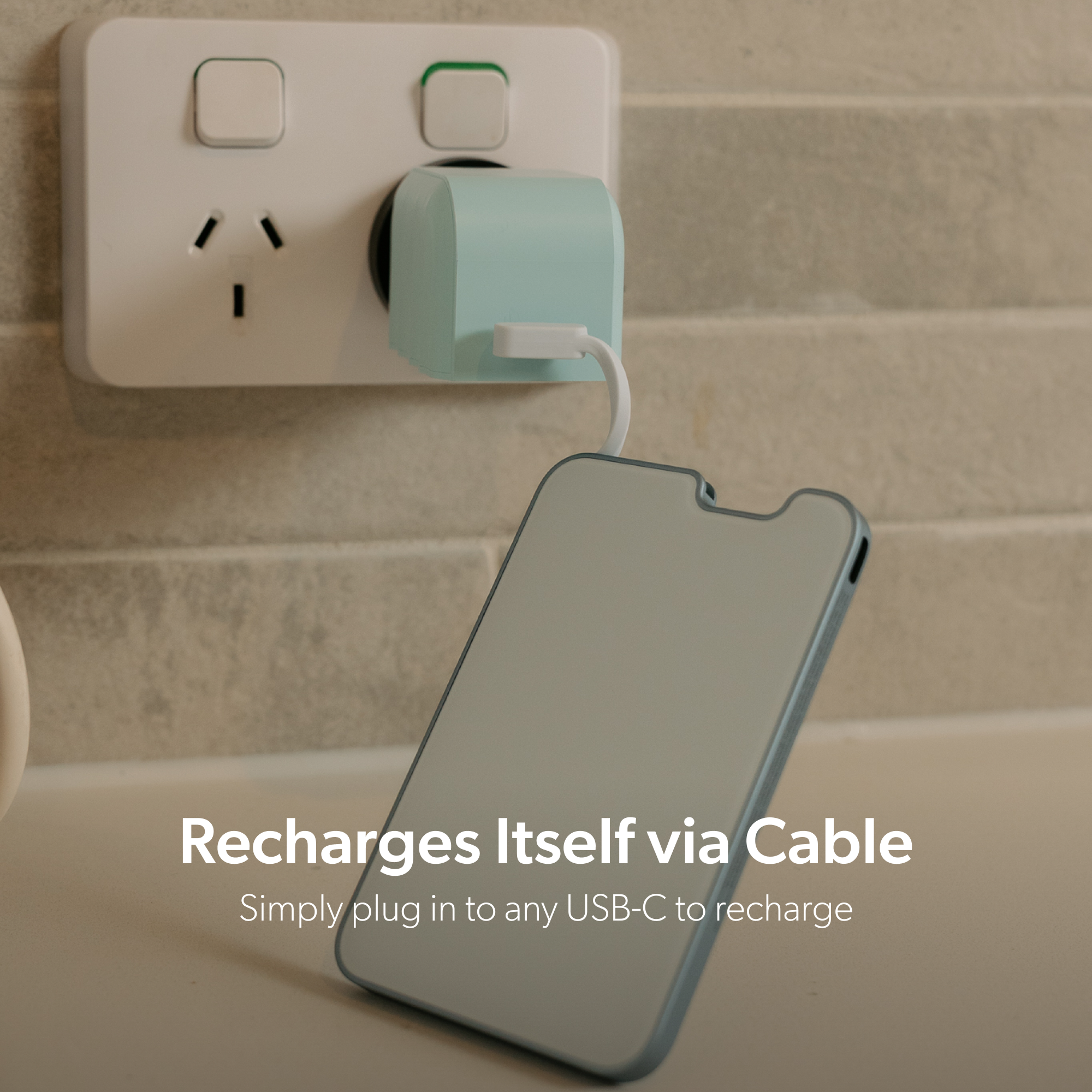 PowerPack Slim 3 recharging through its built-in USB-C cable from a wall charger