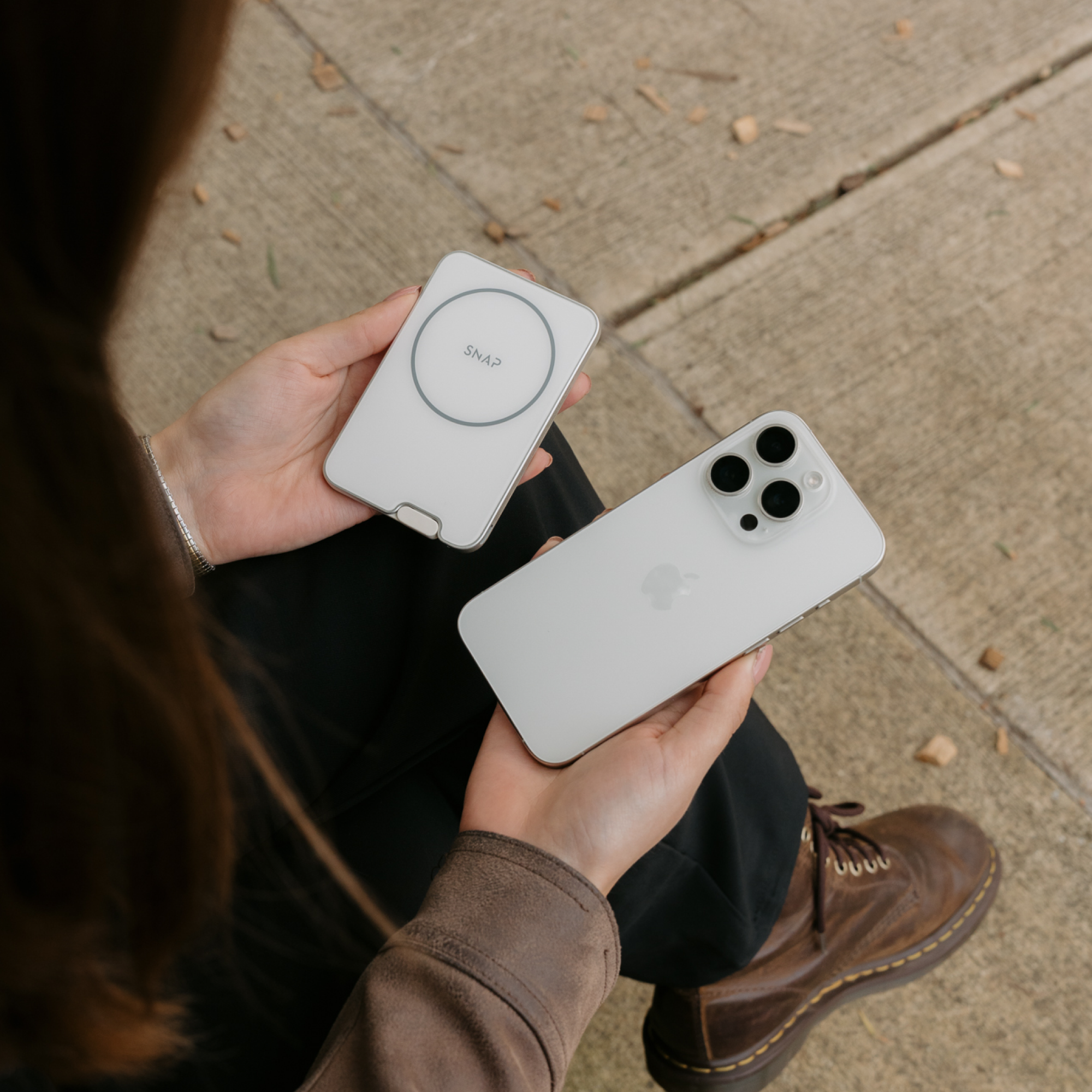 Woman holding an Arctic Silver PowerPack Slim 3 beside a smartphone