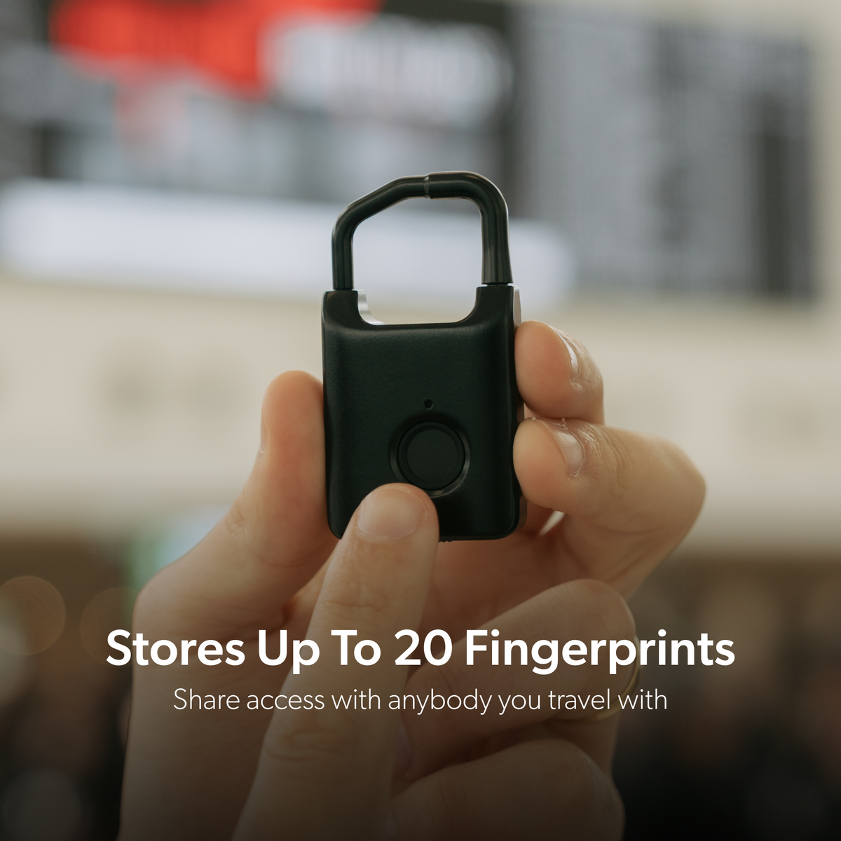 Hand holding a black Trvlr Lock with a caption showing capacity for up to 20 fingerprints.