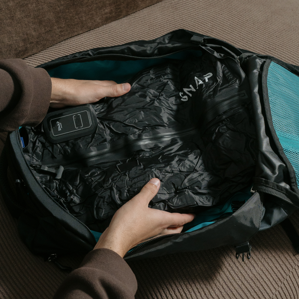 Packing a compressed TRVLR Vacuum Bag into a backpack